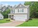 Charming two-story home featuring a two-car garage and a well manicured lawn at 130 Bingley Ct, Covington, GA 30016