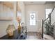 Inviting foyer with stylish decor, wood floors, and ample natural light at 130 Bingley Ct, Covington, GA 30016
