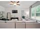 Comfortable living room with a large sectional sofa, TV, and bright windows at 130 Bingley Ct, Covington, GA 30016