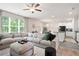 Bright and open living room boasts a large sectional, connecting to a dining room and kitchen at 130 Bingley Ct, Covington, GA 30016