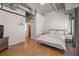 Modern bedroom with exposed ductwork, hardwood floors, and contemporary furnishings at 260 N. 18Th St # 10326, Atlanta, GA 30363