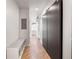 Hallway view features a bench, sliding door and light hardwood floors at 260 N. 18Th St # 10326, Atlanta, GA 30363