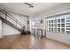 Inviting living room space featuring a staircase, light-filled windows, and stylish wood flooring at 260 N. 18Th St # 10326, Atlanta, GA 30363