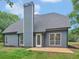 Backyard featuring well manicured lawn, lush landscaping, and the house with a chimney at 30 Stonewall Dr, Covington, GA 30016