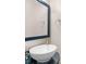 Modern bathroom showcasing an oval vessel sink, a large mirror with a navy frame, and stylish fixtures at 30 Stonewall Dr, Covington, GA 30016