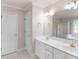 Elegant bathroom with double sinks, white cabinets, and a large mirror with decorative lighting at 30 Stonewall Dr, Covington, GA 30016
