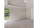 Spacious bedroom features neutral carpeting, a large window, and an ensuite bathroom at 30 Stonewall Dr, Covington, GA 30016