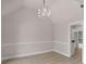 Formal dining area featuring an elegant chandelier and adjacent views and entry into the kitchen at 30 Stonewall Dr, Covington, GA 30016