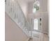 A bright foyer features a staircase with custom railing and a front door with decorative glass at 30 Stonewall Dr, Covington, GA 30016