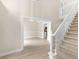 Elegant foyer features a staircase and entry into the dining room and kitchen with hardwood floors at 30 Stonewall Dr, Covington, GA 30016
