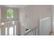 Bright foyer featuring a chandelier above the front door, with views to the upstairs landing at 30 Stonewall Dr, Covington, GA 30016