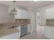 Well-lit kitchen with white cabinets, stainless steel appliances, and granite countertops at 30 Stonewall Dr, Covington, GA 30016