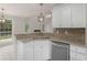 Stylish kitchen featuring granite countertops, white cabinetry, and stainless steel appliances with an open layout at 30 Stonewall Dr, Covington, GA 30016