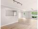 Open living room with large windows offering plenty of natural light and hardwood flooring at 30 Stonewall Dr, Covington, GA 30016