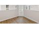Bright home office featuring wood-look flooring, white trim, and a glass paneled door for natural light at 30 Stonewall Dr, Covington, GA 30016