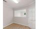 Bright home office featuring wood-look flooring, white trim, and a glass paneled door for natural light at 30 Stonewall Dr, Covington, GA 30016
