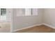 Bright home office featuring wood-look flooring, white trim, and a glass paneled door for natural light at 30 Stonewall Dr, Covington, GA 30016