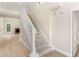 Bright foyer showcasing a staircase leading to an open floorplan and living area with fireplace at 30 Stonewall Dr, Covington, GA 30016