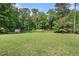 Spacious backyard featuring a grassy area and storage shed at 325 N Oakland Cir, Mcdonough, GA 30253