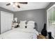 Bedroom includes a queen bed with many pillows, a ceiling fan, and a closet at 325 N Oakland Cir, Mcdonough, GA 30253