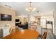Open dining area with wooden table and view to the kitchen and living room at 325 N Oakland Cir, Mcdonough, GA 30253