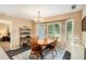 Charming dining room with wood table, chairs, and a bay window at 325 N Oakland Cir, Mcdonough, GA 30253