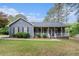 Charming single-story home with a welcoming front porch and well-maintained landscaping at 325 N Oakland Cir, Mcdonough, GA 30253