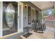 Inviting front porch with rocking chairs and a view of the neighborhood at 325 N Oakland Cir, Mcdonough, GA 30253