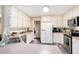 Well-lit kitchen featuring stainless steel appliances and white cabinetry at 325 N Oakland Cir, Mcdonough, GA 30253