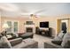 Cozy living room features a fireplace, ceiling fan, and comfortable seating at 325 N Oakland Cir, Mcdonough, GA 30253