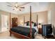 Bright main bedroom boasts a four-poster bed and ensuite bathroom at 325 N Oakland Cir, Mcdonough, GA 30253