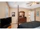 Bedroom with a four-poster bed and doorway views to the kitchen at 325 N Oakland Cir, Mcdonough, GA 30253