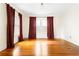 Airy bedroom with hardwood floors, crown molding, and large windows with elegant curtains at 364 Brooks Ne Ave, Atlanta, GA 30307