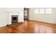 Inviting living room highlighting hardwood floors, a fireplace, and unique window details at 364 Brooks Ne Ave, Atlanta, GA 30307