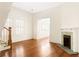 Bright living room with fireplace, hardwood floors, and natural light from large windows at 364 Brooks Ne Ave, Atlanta, GA 30307