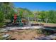 Community playground featuring colorful slides, play structures, picnic tables and ample seating surrounded by lush trees at 364 Brooks Ne Ave, Atlanta, GA 30307