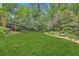 Expansive backyard featuring lush greenery and mature trees provides a private outdoor space at 2440 Peachtree Nw Rd # 9, Atlanta, GA 30305