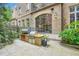 Outdoor kitchen and patio area with lush landscaping in a brick townhouse backyard at 2440 Peachtree Nw Rd # 9, Atlanta, GA 30305