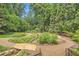 Expansive backyard featuring a winding gravel path and lush landscaping at 2440 Peachtree Nw Rd # 9, Atlanta, GA 30305