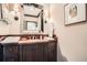 Elegant bathroom with dark wood cabinetry, a large mirror, stylish sconces, and a sink at 2440 Peachtree Nw Rd # 9, Atlanta, GA 30305