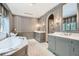 Luxurious bathroom boasting dual vanities, marble countertops, elegant gray cabinetry, and a soaking tub at 2440 Peachtree Nw Rd # 9, Atlanta, GA 30305
