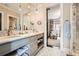 Elegant bathroom featuring double vanity with marble countertops, and a glass-enclosed shower at 2440 Peachtree Nw Rd # 9, Atlanta, GA 30305