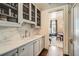 Butler's pantry with marble countertops, stainless steel sink and wire-front cabinets at 2440 Peachtree Nw Rd # 9, Atlanta, GA 30305