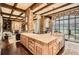 Gourmet kitchen with a large island, brick walls, exposed beams and an adjacent living space at 2440 Peachtree Nw Rd # 9, Atlanta, GA 30305