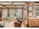 Bright living room featuring exposed brick, wood beams, and stylish furniture at 2440 Peachtree Nw Rd # 9, Atlanta, GA 30305