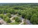Aerial view showcases the homes nestled amongst mature trees in a verdant and well-established neighborhood at 3004 High Vista Walk, Woodstock, GA 30189
