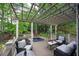 Relaxing back deck features a spa, overhead pergola, lounge chairs and lush greenery, perfect for outdoor living at 3004 High Vista Walk, Woodstock, GA 30189