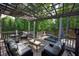 Comfortable outdoor deck with overhead pergola, patio seating, and a relaxing spa, offering a serene retreat at 3004 High Vista Walk, Woodstock, GA 30189
