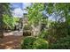 Charming back exterior showcasing a spacious deck, lush landscaping, and serene outdoor living at 3004 High Vista Walk, Woodstock, GA 30189