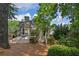 Back exterior showcasing a spacious deck, well-maintained landscaping, and a serene outdoor setting at 3004 High Vista Walk, Woodstock, GA 30189